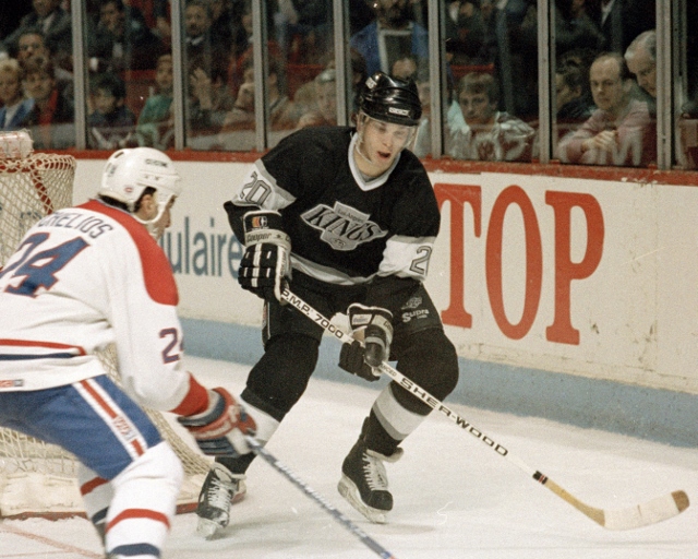 MONTREAL 1990's: Luc Robitaille #20 of the Los Angeles Kings skates Chris Chelios #24 of against the Montreal Canadiens in the 1990's at the Montreal Forum in Montreal, Quebec, Canada. (Photo by Denis Brodeur/NHLI via Getty Images)