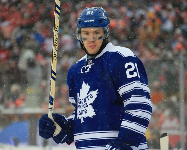 ANN ARBOR, MI - JANUARY 1:  James van Riemsdyk #21 of the Toronto Maple Leafs gets set for the face-off against the Detroit Red Wings during the Bridgestone NHL Winter Classic on January 1, 2014 at the University of Michigan Stadium in Ann Arbor, Michigan