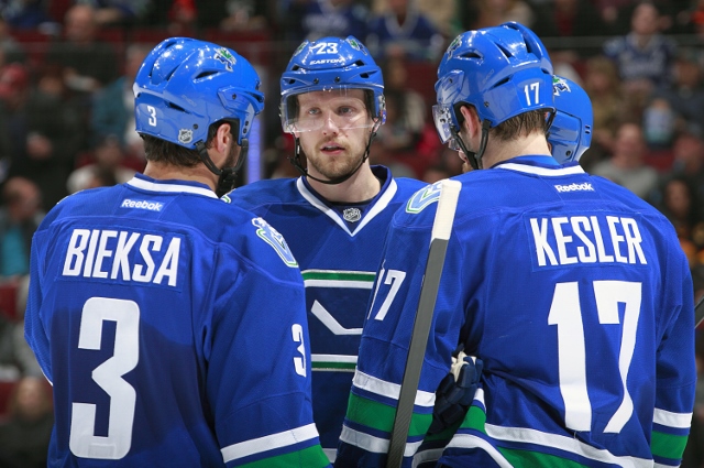 VANCOUVER, BC - MARCH 29:  Alexander Edler #23 of the Vancouver Canucks talks to teammates Kevin Bieksa #3 and Ryan Kesler #17 during their NHL game against the Anaheim Ducks at Rogers Arena March 29, 2014 in Vancouver, British Columbia, Canada.  Anaheim