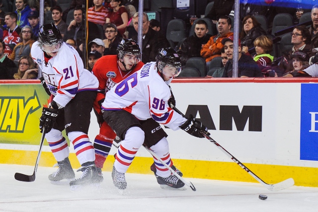 CALGARY, AB - JANUARY 15: Spencer Watson #96 of Team Orr skates with the puck past Jacob Middleton #21 of Team Cherry during the CHL Top Prospects game at Scotiabank Saddledome on January 15, 2014 in Calgary, Alberta, Canada. Team Orr defeated Team Cherry