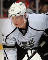 DETROIT, MI - JANUARY 18: Matt Frattin #21 of the Los Angeles Kings gets set for the face-off against the Detroit Red Wings during an NHL game on January 18, 2014 at Joe Louis Arena in Detroit, Michigan. The Red Wings defeated the Kings 3-2 in a shootout