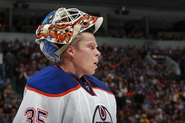 VANCOUVER, BC - OCTOBER 11: Viktor Fasth #35 of the Edmonton Oilers looks on from the bench during their NHL game against the Vancouver Canucks at Rogers Arena October 11, 2014 in Vancouver, British Columbia, Canada.  Vancouver won 5-4 in a shootout. (Pho