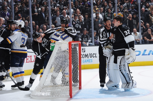 LOS ANGELES, CA - OCTOBER 16: Linesman Darren Gibbs #66 speaks to Jonathan Quick #32 of the Los Angeles Kings while the teams get into a scrum around the net at STAPLES Center on October 16, 2014 in Los Angeles, California. (Photo by Juan Ocampo/NHLI via