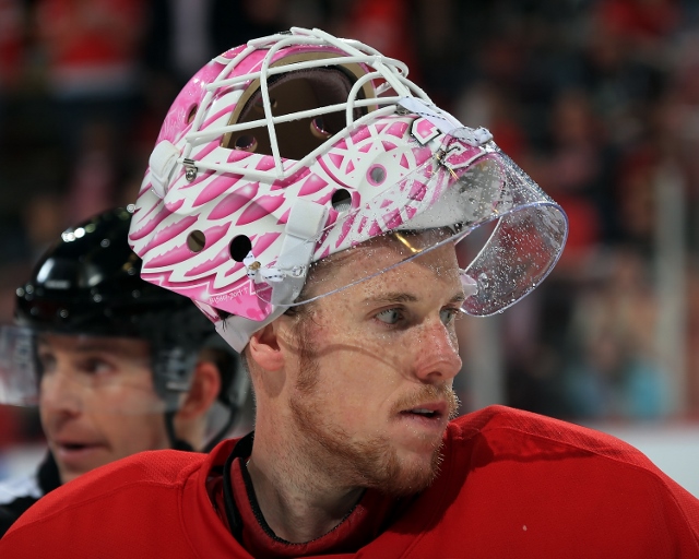 DETROIT, MI - OCTOBER 23: Jimmy Howard #35 of the Detroit Red Wings looks down the ice with his custom painted mask for "Hockey Fights Cancer" night against the Pittsburgh Penguins during a NHL game on October 23, 2014 at Joe Louis Arena in Detroit, Michi