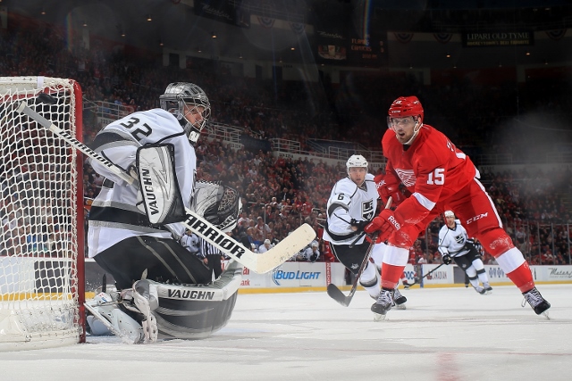 DETROIT, MI - JANUARY 18: Jonathan Quick #32 of the Los Angeles Kings makes a save on Riley Sheahan #15 of the Detroit Red Wings during an NHL game on January 18, 2014 at Joe Louis Arena in Detroit, Michigan. The Red Wings defeated the Kings 3-2 in a shoo