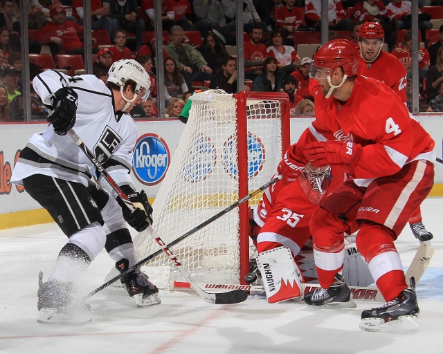 DETROIT, MI - JANUARY 18: Jakub Kindl #4 and Jimmy Howard #35 of the Detroit Red Wings defend the corner of the net as Justin Williams #14 of the Los Angeles Kings tries to score during an NHL game on January 18, 2014 at Joe Louis Arena in Detroit, Michig