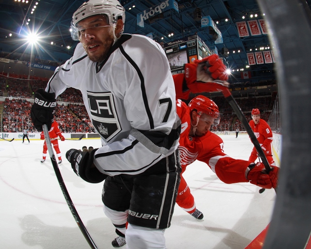 DETROIT, MI - OCTOBER 31: Dwight King #74 of the Los Angeles Kings and Niklas Kronwall #55 of the Detroit Red Wings battle in the corner in the second period during a NHL game on October 31, 2014 at Joe Louis Arena in Detroit, Michigan. (Dave Reginek/NHLI