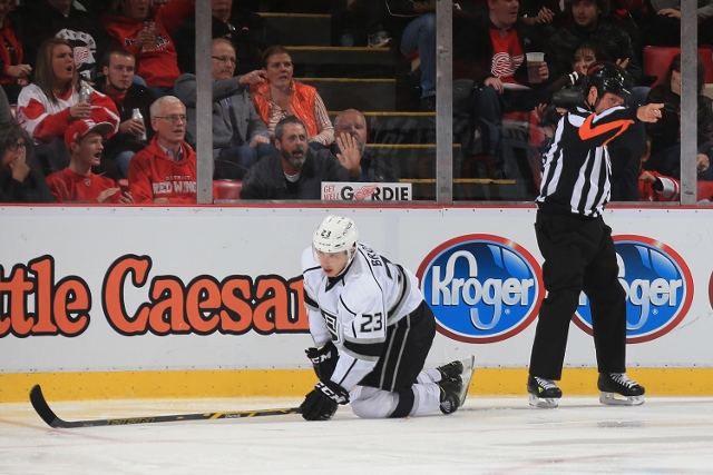 DETROIT, MI - OCTOBER 31: Dustin Brown #23 of the Los Angeles Kings is awarded a penalty shot in the third period by referee Paul Devorski #10 during a NHL game against the Detroit Red Wings on October 31, 2014 at Joe Louis Arena in Detroit, Michigan. The