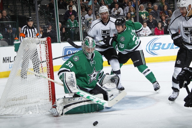 DALLAS, TX - DECEMBER 31:  Kari Lehtonen #32 of the Dallas Stars kicks aside a shot by Dwight King #74 of the Los Angeles Kings at the American Airlines Center on December 31, 2013 in Dallas, Texas.  (Photo by Glenn James/NHLI via Getty Images)