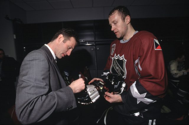 Dominik Hasek autographs a glove